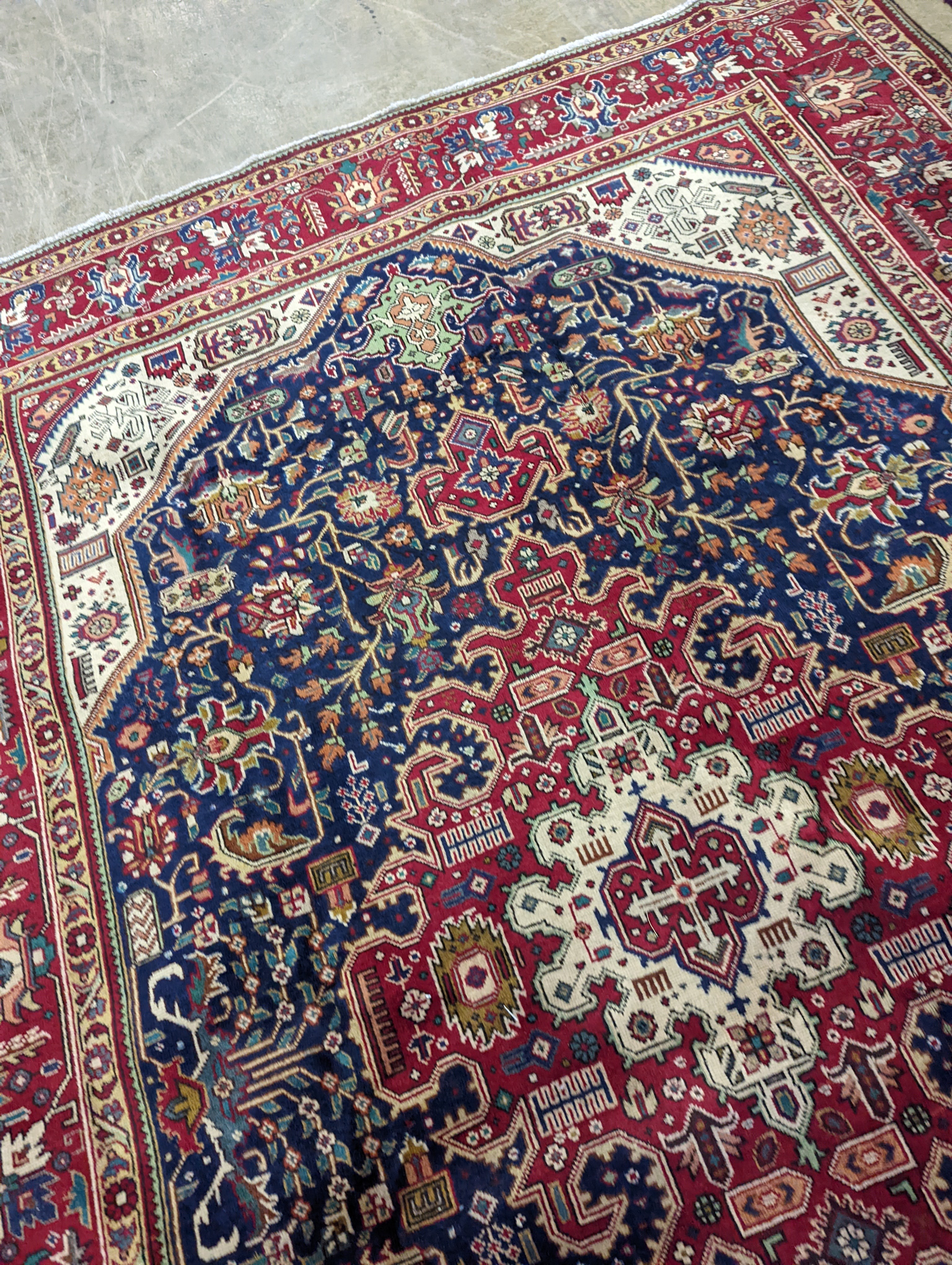 A Tabriz blue ground carpet, 290 x 200cm